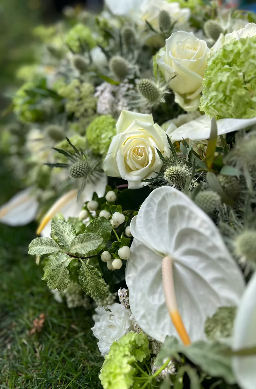 Casket Spray – Modern Funeral Tribute Flowers (Calla Lily, Rose & Thistle)