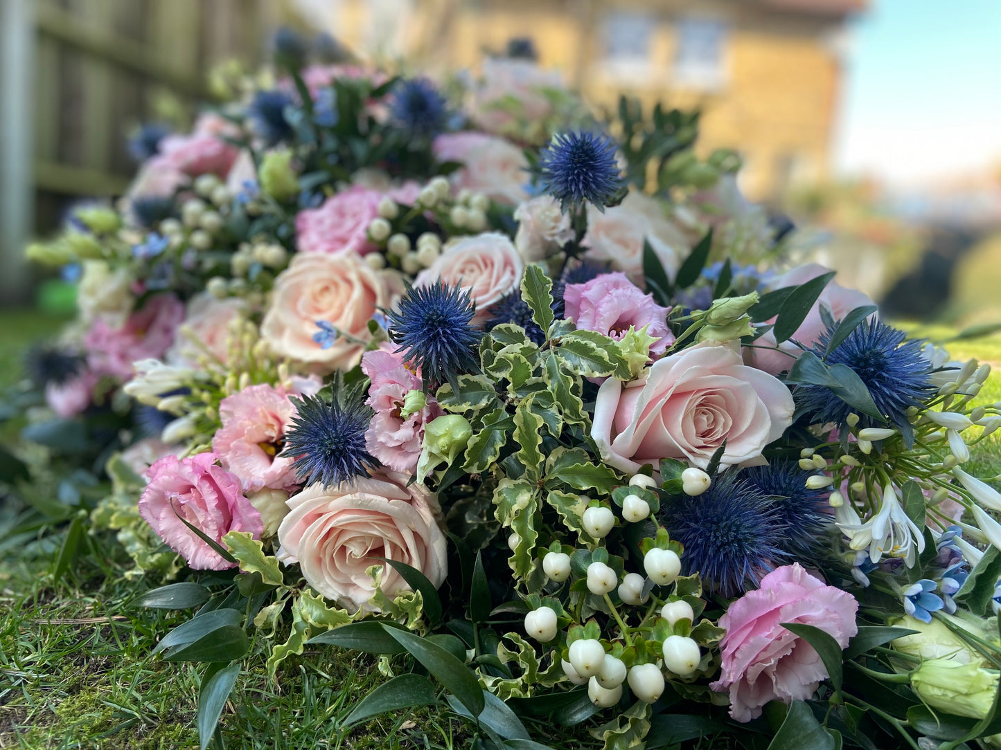 Casket Spray – Pink & Blue Funeral Tribute Flowers (Rose, Thistle & Agapanthus)