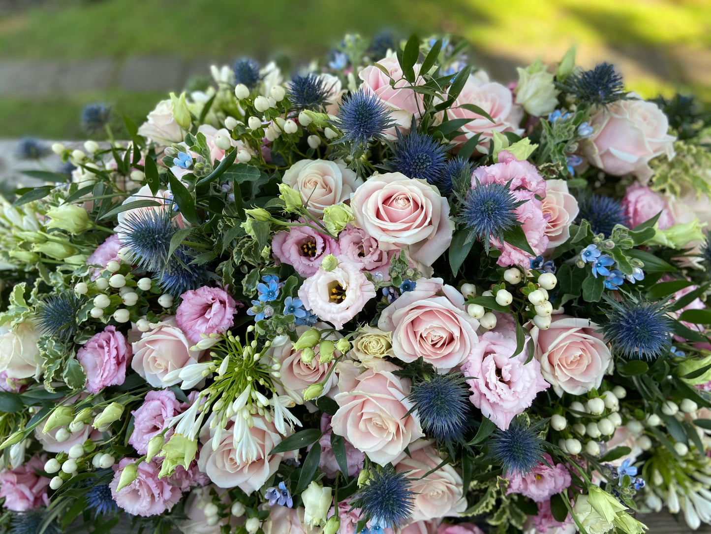 Casket Spray – Pink & Blue Funeral Tribute Flowers (Rose, Thistle & Agapanthus)
