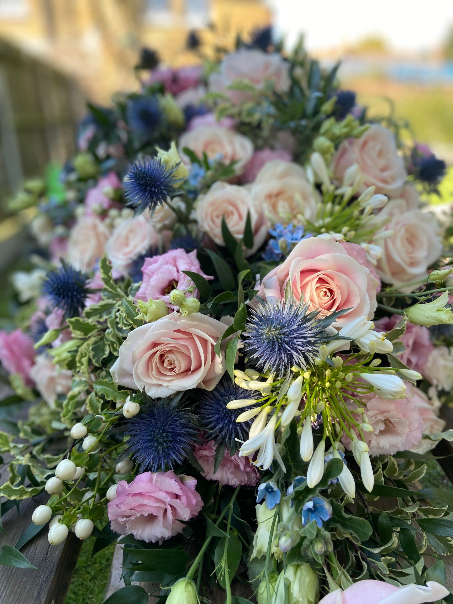 Casket Spray – Pink & Blue Funeral Tribute Flowers (Rose, Thistle & Agapanthus)