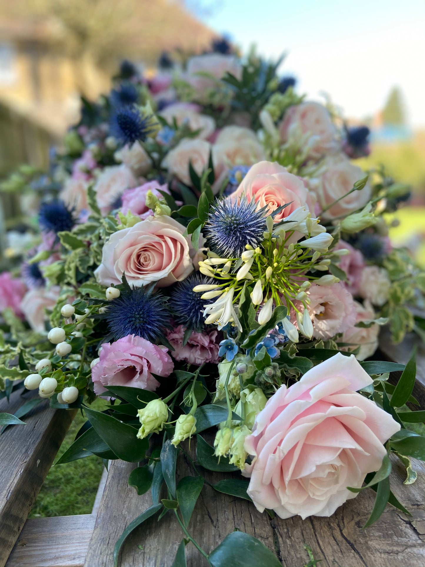 Casket Spray – Pink & Blue Funeral Tribute Flowers (Rose, Thistle & Agapanthus)