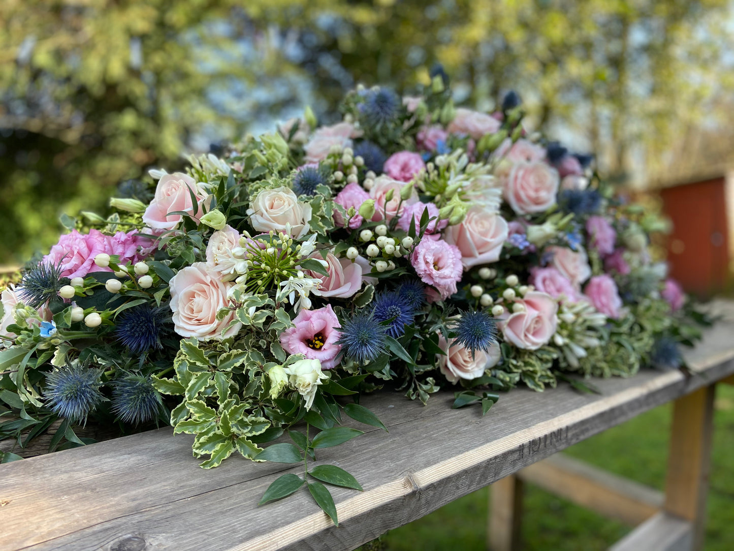 Casket Spray – Pink & Blue Funeral Tribute Flowers (Rose, Thistle & Agapanthus)