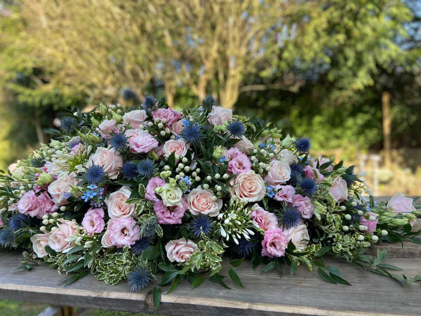 Casket Spray – Pink & Blue Funeral Tribute Flowers (Rose, Thistle & Agapanthus)