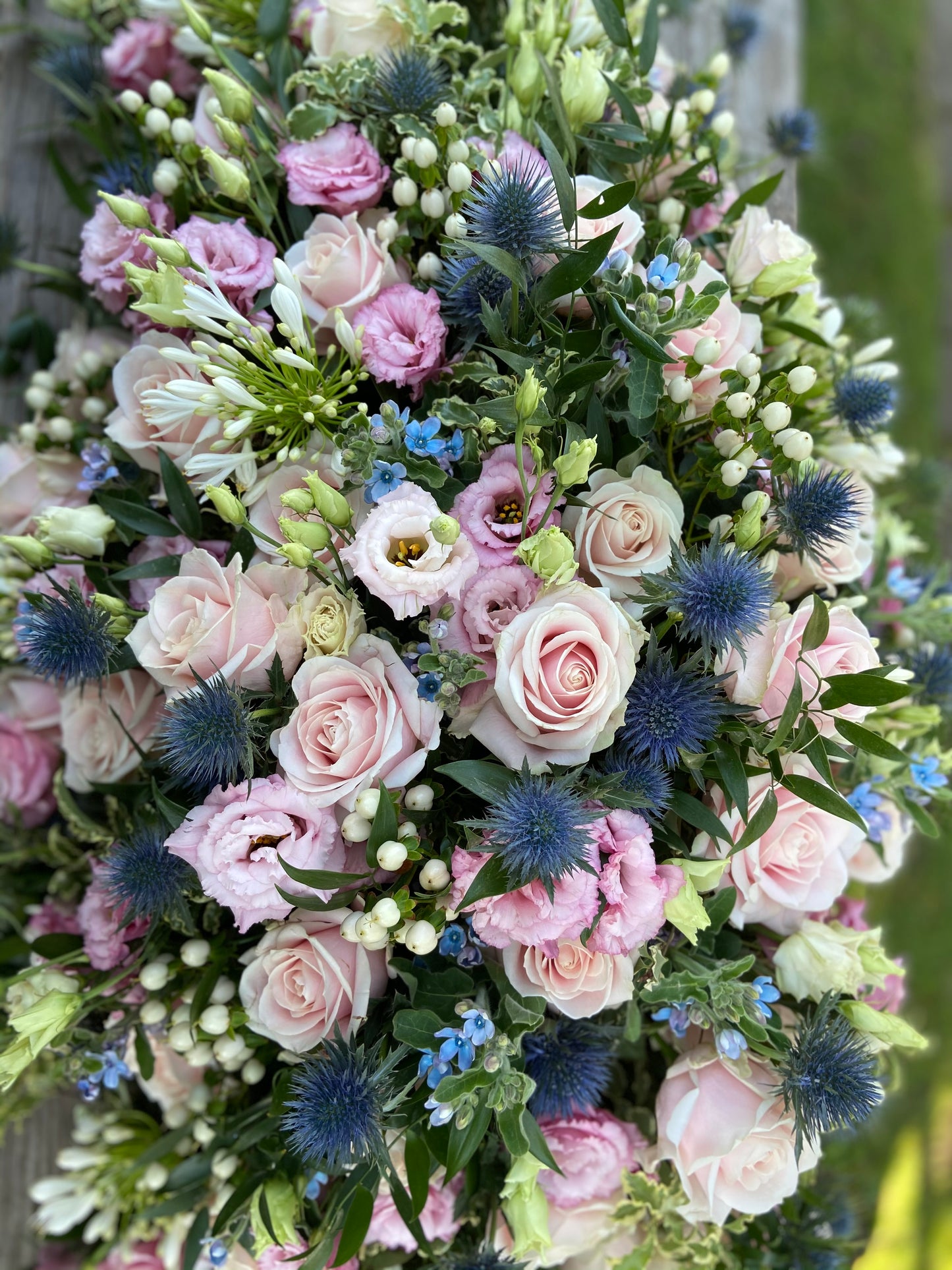 Casket Spray – Pink & Blue Funeral Tribute Flowers (Rose, Thistle & Agapanthus)