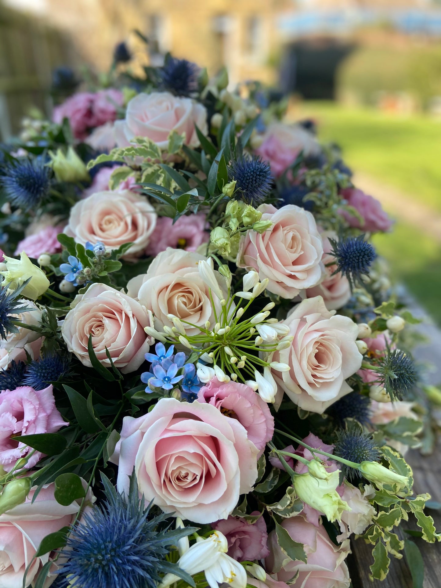 Casket Spray – Pink & Blue Funeral Tribute Flowers (Rose, Thistle & Agapanthus)