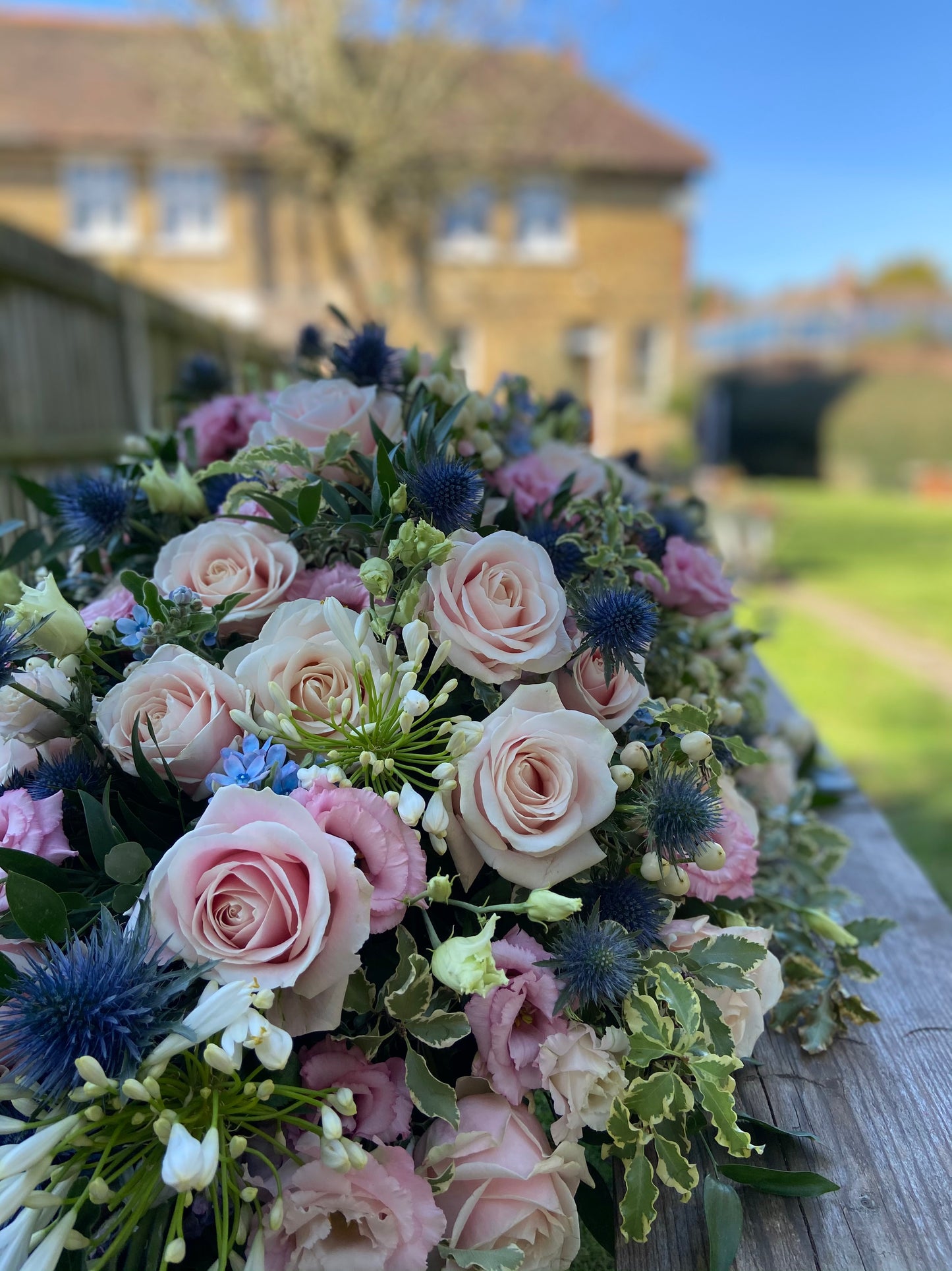 Casket Spray – Pink & Blue Funeral Tribute Flowers (Rose, Thistle & Agapanthus)