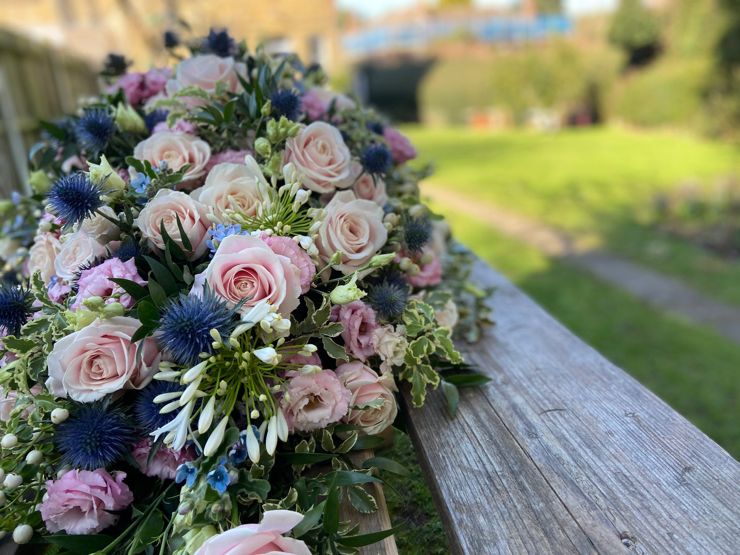 Casket Spray – Pink & Blue Funeral Tribute Flowers (Rose, Thistle & Agapanthus)