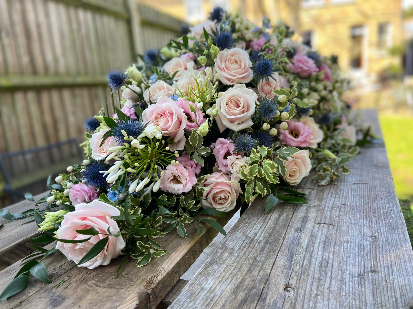 Casket Spray – Pink & Blue Funeral Tribute Flowers (Rose, Thistle & Agapanthus)